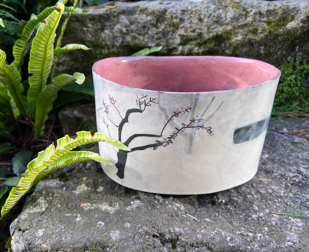 handbuilt and handpainted beautoful large bowl with pink interior and cream exterior with trees on it by Anna Lambert | Cornwall Contemporary