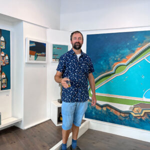 a photograph of the artist Alasdair Lindsay at his exhibition in Cornwall Contemporary gallery in Penzance, Cornwall
